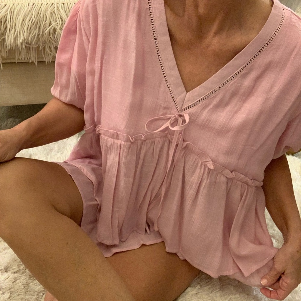 Pretty pink top, L, empire waist, ruffle and open work trim details. 23” long.